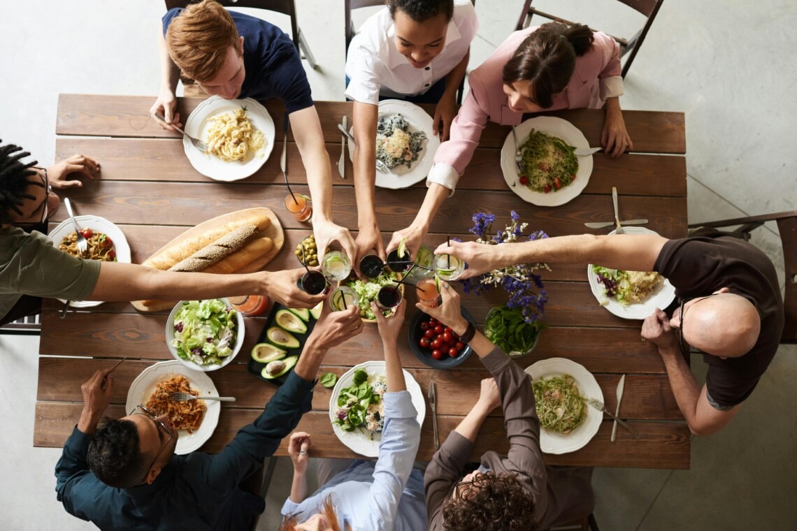 a group of people sitting around a table for thanksgiving dinner