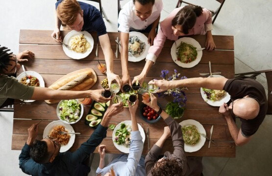 a group of people sitting around a table for thanksgiving dinner