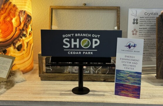 a display of signs and other items on a table at one of the local shops in Cedar Park Texas