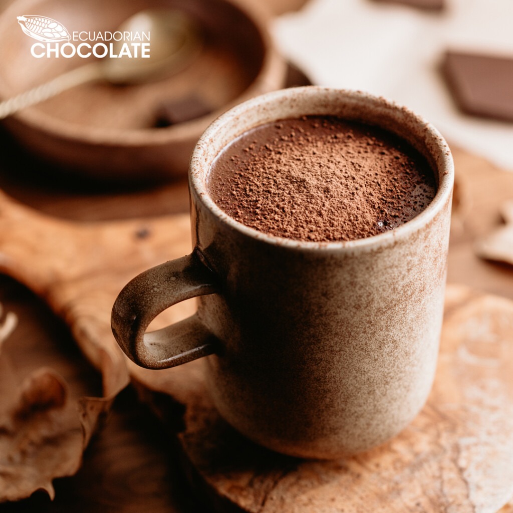 A cup of rich hot chocolate drink on a wooded table offered by The Ecuadorian Chocolate