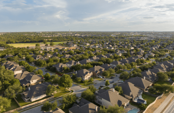 Bird’s-eye view of a picturesque neighborhood in Cedar Park, Texas, featuring tree-lined streets, beautiful homes, and a tranquil suburban setting.