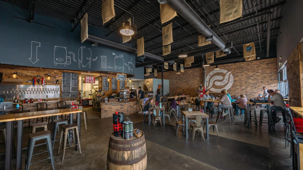 Interior view of Red Horn Coffee House and Brewing Co. in Cedar Park, Texas, featuring rustic wooden furniture and a cozy, inviting atmosphere.