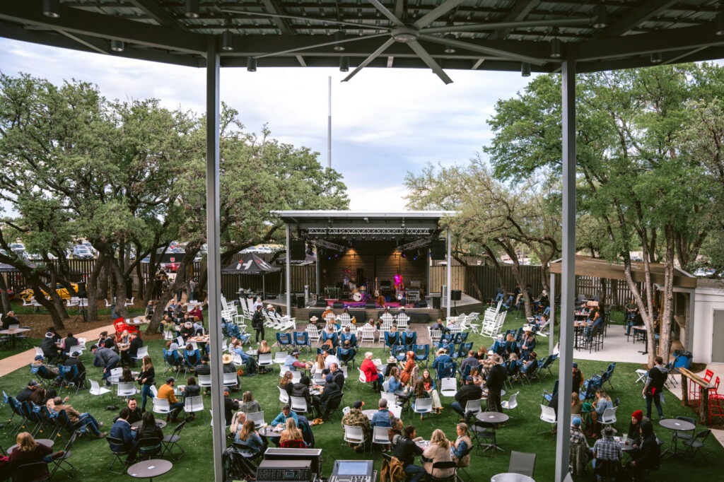 People enjoying a live outdoor concert at Haute Spot during a Cedar Park Summer vacation in Texas