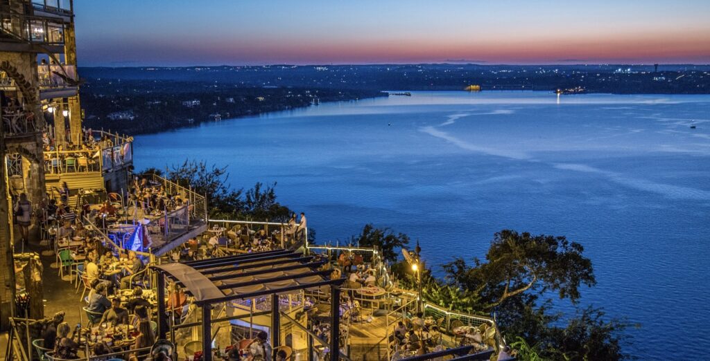 Al fresco dining area with a beautiful lakeview of Lake Travis in Cedar Park, featuring outdoor seating and a scenic, relaxing atmosphere.
