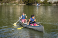 Paddle boats on a lake in Cedar Park, Texas, with people enjoying a summer activity.
